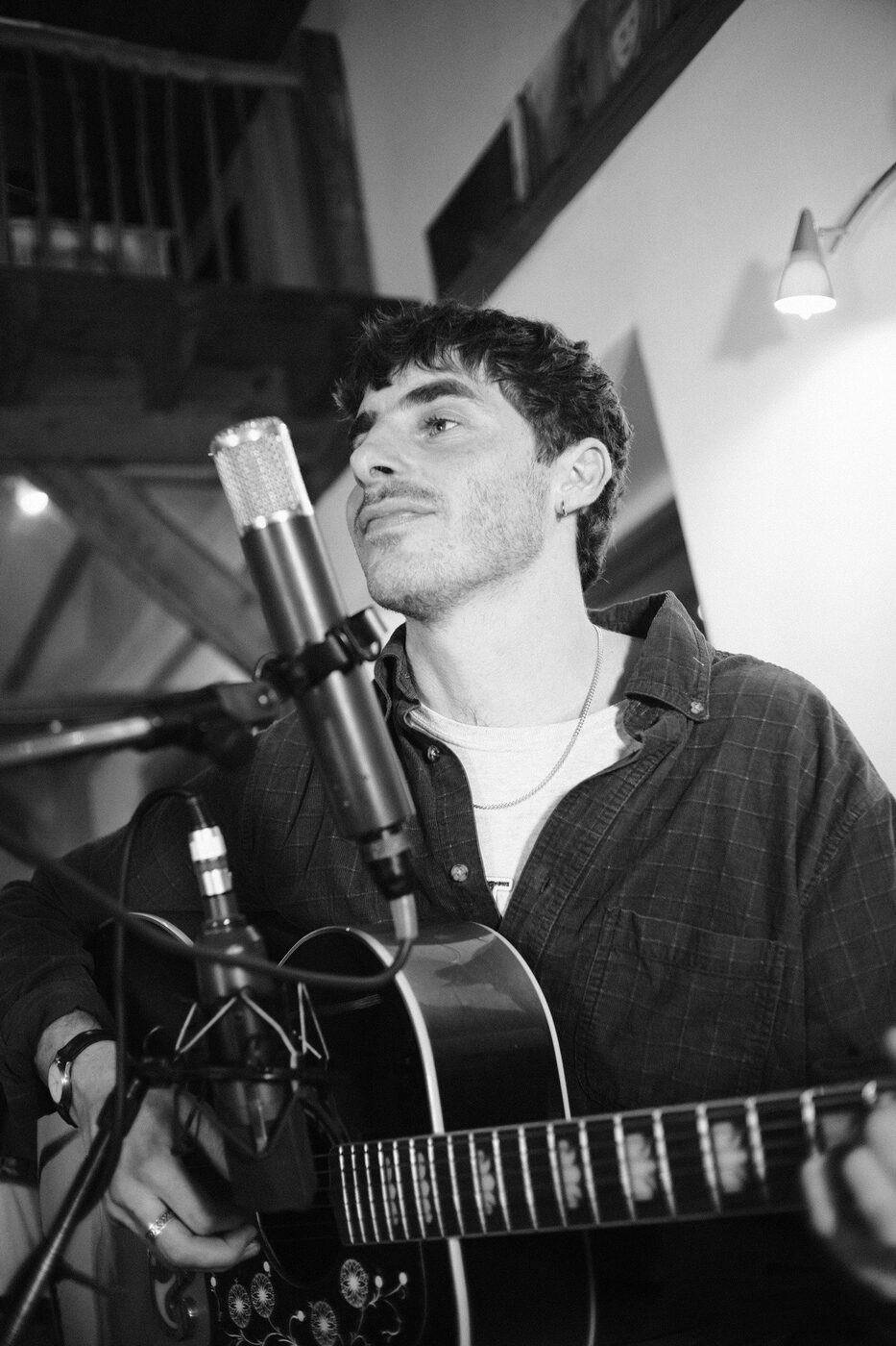 Guitarist recording at a condenser mic at TPot Recording Studios