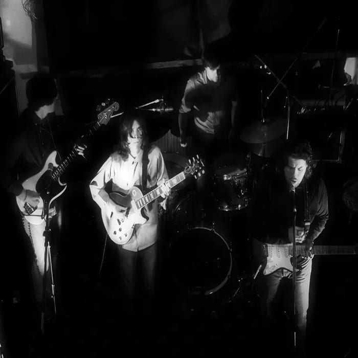 The View performing live at TPot Recording Studios — black-and-white shot of the band on stage with guitars and drums